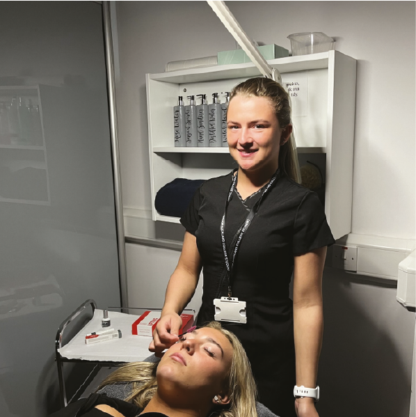 Students performing a beauty therapy treatment