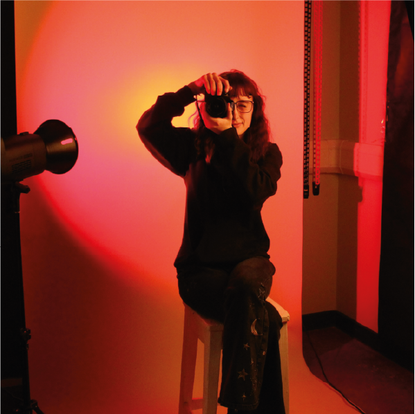 Photography student holding up a DSLR camera