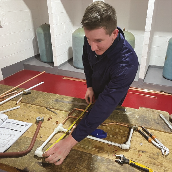 Student learning plumbing skills